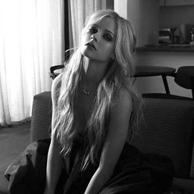 Avril Lavigne sitting pretty in Black and White